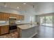 Open kitchen layout with an island, stainless steel appliances, and backyard access at 927 W Azalea Pl, Chandler, AZ 85248