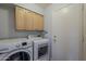 Laundry room featuring a side-by-side washer and dryer set and overhead cabinets at 927 W Azalea Pl, Chandler, AZ 85248
