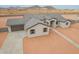 Aerial view of single-story home with a convenient driveway and desert surroundings at 9430 W Sandstone Mountain Dr, Casa Grande, AZ 85194