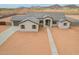 Aerial view showcasing a single-story house with desert landscaping and convenient driveway access at 9430 W Sandstone Mountain Dr, Casa Grande, AZ 85194