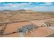 Aerial view of single-story home with desert landscaping and mountain views in the distance at 9430 W Sandstone Mountain Dr, Casa Grande, AZ 85194