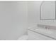 A minimalist powder room with a sleek vanity, modern sink, neutral color palette and mirror at 9430 W Sandstone Mountain Dr, Casa Grande, AZ 85194