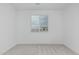 An unfurnished bedroom has neutral carpet, a window, and white door and trim at 9430 W Sandstone Mountain Dr, Casa Grande, AZ 85194