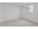 A clean and simple bedroom with neutral carpet and a window provides ample light at 9430 W Sandstone Mountain Dr, Casa Grande, AZ 85194