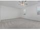 Spacious bedroom with neutral carpet, ceiling fan, and bright natural light from the windows at 9430 W Sandstone Mountain Dr, Casa Grande, AZ 85194