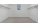 Large walk-in closet with rod, neutral carpet, and ample storage space at 9430 W Sandstone Mountain Dr, Casa Grande, AZ 85194