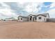 Charming single-story home featuring desert landscaping, with a walkway to the arched front door at 9430 W Sandstone Mountain Dr, Casa Grande, AZ 85194