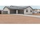 Exterior view of a home with a three-car garage and desert landscaping, blending seamlessly with the natural surroundings at 9430 W Sandstone Mountain Dr, Casa Grande, AZ 85194
