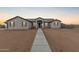 Stunning single-story home showcasing a desert landscape and a walkway leading to the front door at 9430 W Sandstone Mountain Dr, Casa Grande, AZ 85194