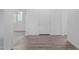 Bright hallway with wood-look flooring, white walls, and views into another room at 9430 W Sandstone Mountain Dr, Casa Grande, AZ 85194