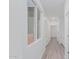 Hallway with wood-look floors, white walls, and a window allowing for natural light and a clean aesthetic at 9430 W Sandstone Mountain Dr, Casa Grande, AZ 85194