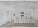Bright kitchen featuring modern island with bar stool seating, stainless steel appliances, and white cabinetry at 9430 W Sandstone Mountain Dr, Casa Grande, AZ 85194