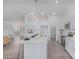 Bright kitchen featuring modern island with bar stool seating, stainless steel appliances, and white cabinetry at 9430 W Sandstone Mountain Dr, Casa Grande, AZ 85194