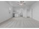 Open living area with bar, beverage fridge, carpet, and neutral paint for a modern feel at 9430 W Sandstone Mountain Dr, Casa Grande, AZ 85194