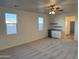 Comfortable living room featuring plush carpeting, stylish fan, and convenient wet bar area at 9430 W Sandstone Mountain Dr, Casa Grande, AZ 85194