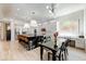 Spacious kitchen featuring a black marble island, white cabinetry, and dining area at 10843 E Acacia Dr, Scottsdale, AZ 85255