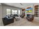 Comfortable living room with a fireplace, TV, and views of the outdoor pool and patio at 10843 E Acacia Dr, Scottsdale, AZ 85255
