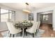 Bright dining room featuring a stylish chandelier, seating for eight, and views of the adjacent room at 12048 N 146Th Ave, Surprise, AZ 85379