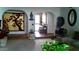 Living room with archways, neutral carpet, and decorative house plants at 1222 E Acoma Dr, Phoenix, AZ 85022