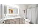 Well-lit bathroom with a large mirror, gray vanity, and a shower-tub combination at 2780 E Lindrick Dr, Chandler, AZ 85249