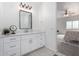 Stylish bathroom with white cabinets, modern fixtures, and a view leading into the Primary bedroom at 6515 N Loma Ct, Casa Grande, AZ 85194