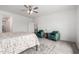 Cozy bedroom featuring a ceiling fan, soft rug, and a seating area with comfortable green chairs at 6515 N Loma Ct, Casa Grande, AZ 85194