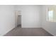 This is a bedroom with a window and an open closet at 6515 N Loma Ct, Casa Grande, AZ 85194
