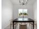 Minimalist dining area with a window, black table and modern seating at 6515 N Loma Ct, Casa Grande, AZ 85194