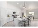 Modern kitchen with white cabinets, stainless steel appliances, central island with seating, open to dining area at 6515 N Loma Ct, Casa Grande, AZ 85194
