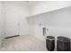 Bright laundry room featuring white walls, tiled floors, ample shelving, and washer/dryer hookups at 6515 N Loma Ct, Casa Grande, AZ 85194