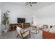Staged living room featuring hardwood floors, ceiling fan, and stylish furniture at 6515 N Loma Ct, Casa Grande, AZ 85194