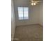 Bright bedroom featuring neutral carpet, ceiling fan, and a window with blinds at 8659 E Mescal St, Scottsdale, AZ 85260