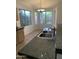 Well-lit kitchen showcasing tile counters, stainless sink, and bright windows at 8659 E Mescal St, Scottsdale, AZ 85260