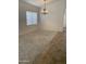 Living room features neutral carpet, modern lighting fixture, and bright window at 8659 E Mescal St, Scottsdale, AZ 85260