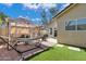 Cozy backyard featuring a covered seating area, a hammock, and artificial turf at 8972 E Arizona Park Pl, Scottsdale, AZ 85260