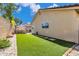 Lush backyard featuring artificial turf, stepping stones, and a cozy gazebo area for outdoor relaxation and entertaining at 8972 E Arizona Park Pl, Scottsdale, AZ 85260