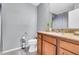 Well-lit bathroom featuring vanity with granite countertop, white toilet, and neutral gray walls at 8972 E Arizona Park Pl, Scottsdale, AZ 85260
