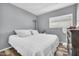 Bright, simple bedroom with a comfortable bed, window, and neutral decor with modern fan at 8972 E Arizona Park Pl, Scottsdale, AZ 85260