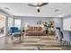 Spacious living area with modern furnishings and a ceiling fan at 8972 E Arizona Park Pl, Scottsdale, AZ 85260