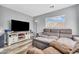 Cozy living room with sectional sofa, TV, and plenty of natural light at 8972 E Arizona Park Pl, Scottsdale, AZ 85260