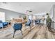 Spacious open-concept living and dining area with modern furnishings, including a ceiling fan and adjacent breakfast bar at 8972 E Arizona Park Pl, Scottsdale, AZ 85260
