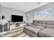 Inviting living room with sectional sofa, TV, and plenty of natural light at 8972 E Arizona Park Pl, Scottsdale, AZ 85260