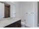 Modern bathroom with a large mirror, white countertops, and sleek fixtures at 100 W Northern Ave # 15, Phoenix, AZ 85021