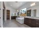Luxurious bathroom with a soaking tub and dual vanities with modern fixtures and outside view at 100 W Northern Ave # 15, Phoenix, AZ 85021