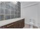 Modern bathroom with stylish vanity, elegant fixtures, and contemporary tile accent wall at 100 W Northern Ave # 15, Phoenix, AZ 85021