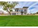 Contemporary home boasts a well-manicured lawn, sleek design, expansive windows, and a dark-colored trim at 100 W Northern Ave # 15, Phoenix, AZ 85021
