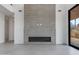 Modern fireplace with electric insert and stylish gray tile surround at 100 W Northern Ave # 15, Phoenix, AZ 85021