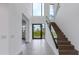 Grand foyer features a floating staircase, high ceilings, and a clear view of the exterior at 100 W Northern Ave # 15, Phoenix, AZ 85021