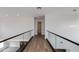 Modern hallway with wood floors, glass railings, and bright recessed lighting at 100 W Northern Ave # 15, Phoenix, AZ 85021