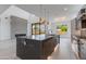 Gourmet kitchen boasts an expansive island, stainless steel appliances, and seamless flow to the living area at 100 W Northern Ave # 15, Phoenix, AZ 85021